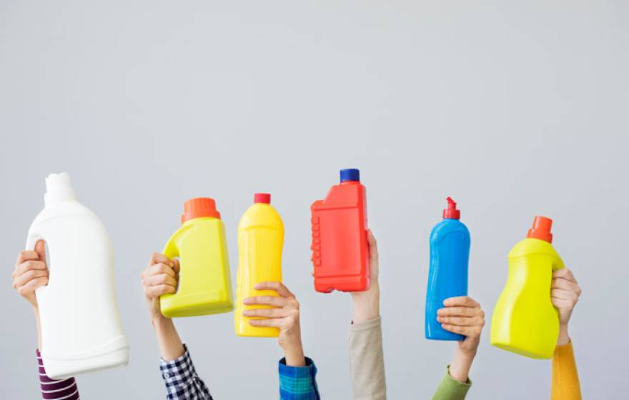 Hands holding up plastic bottles