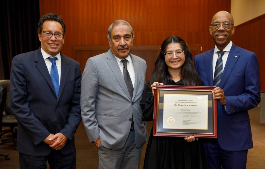 Chair Richard Leib, Chancellor Khosla, a young Latina woman Maribel Patiño, and President Drake 