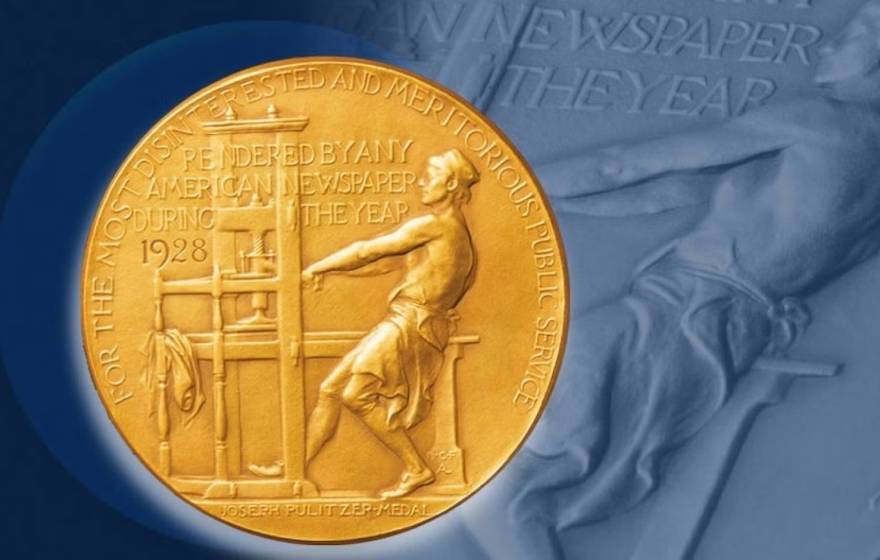 An image of the Pulitzer Prize medal which features a man dressed from the torso down operating an early press