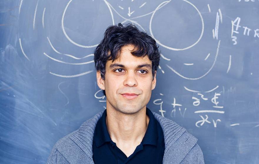 Enrico Ramirez-Ruiz in front of chalkboard