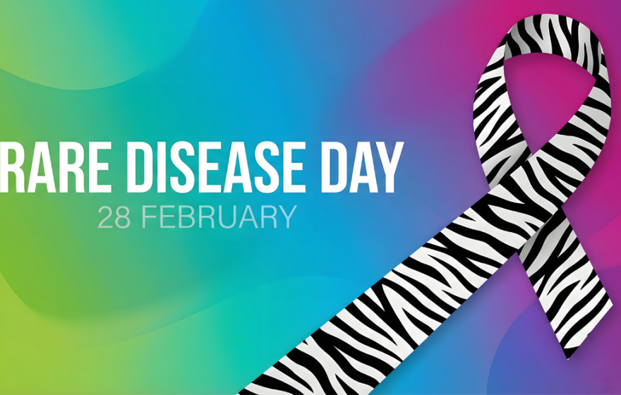 A banner reads "Rare Disease Day February 28" with a zebra ribbon on a rainbow background
