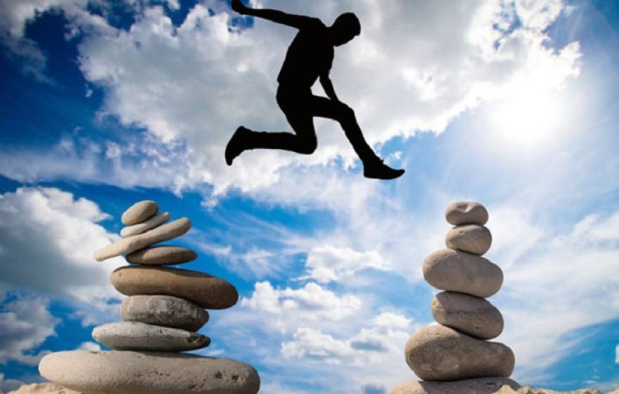 A man jumping over stones