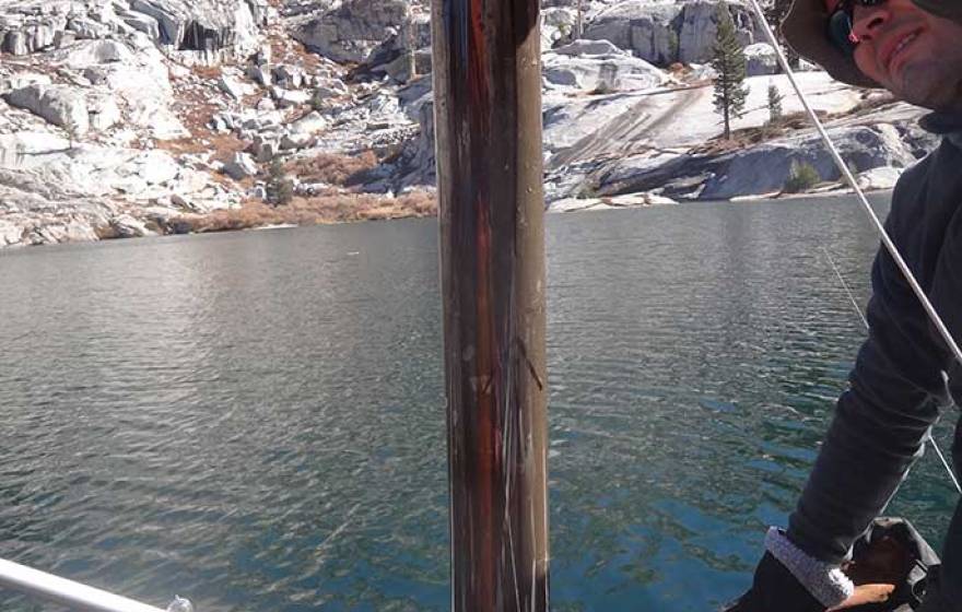 Peter Homyak collects lake sediment core