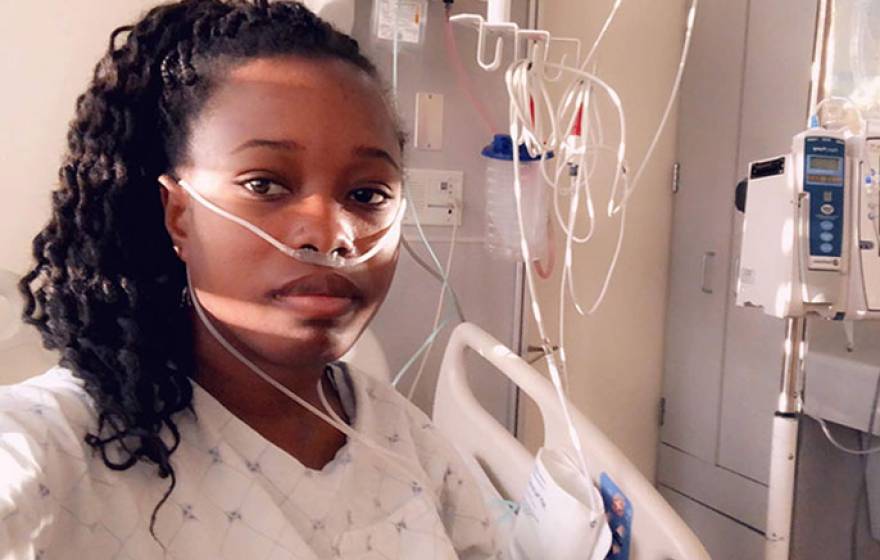 Young Black woman in hospital room