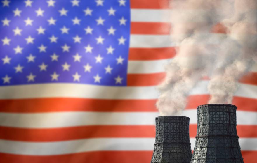 Smokestacks in front of an American flag