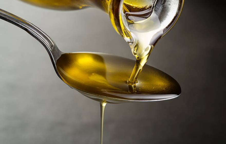 Soybean oil flowing into a spoon