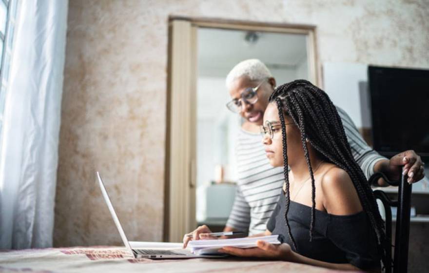 Student and grandparent looking at a computer