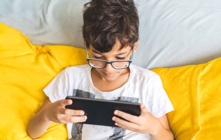 Overhead shot of young student learning on a tablet