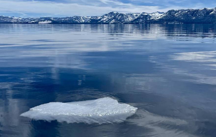 Lake Tahoe in winter with a block of ice in the forefront