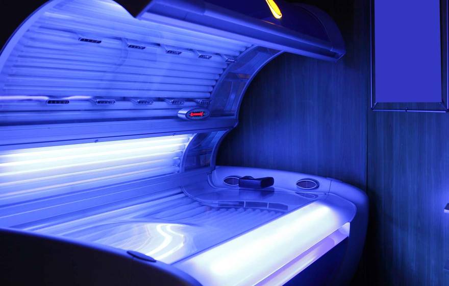 A tanning bed emitting a soft blue glow.