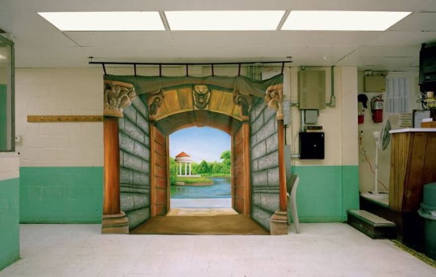 Landscape painting hung in a prison hallway