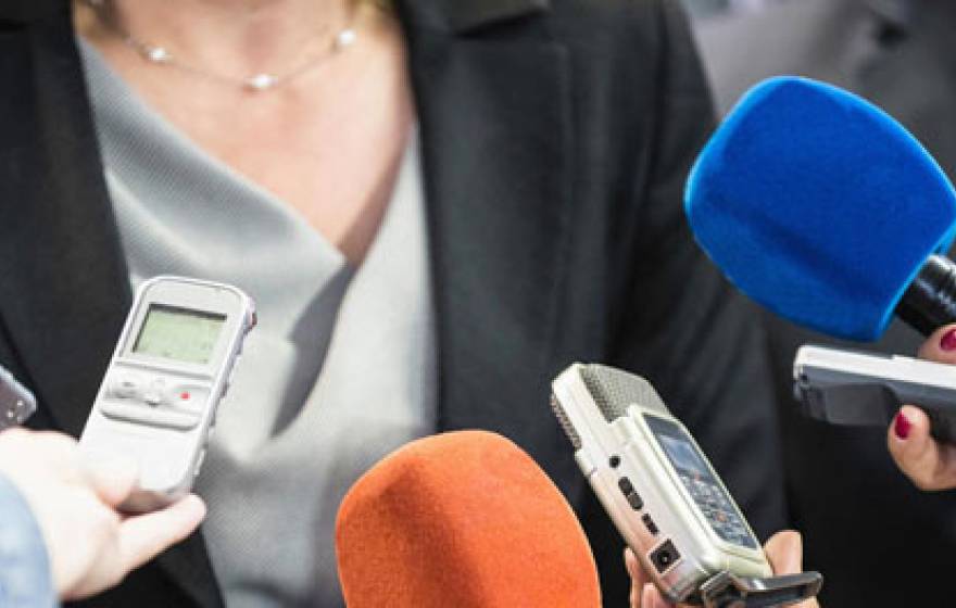 Mics held up to a woman