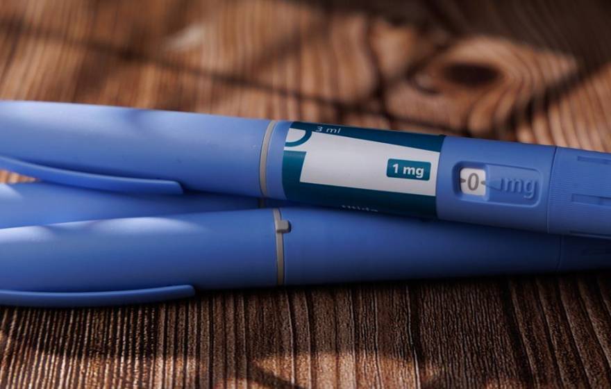 A set of three blue GLP-1 pens