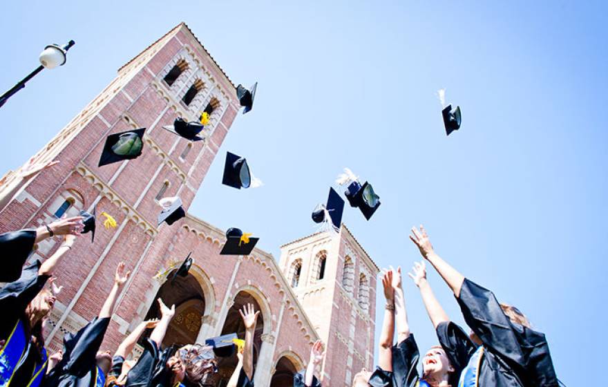 grads toss their mortarboards