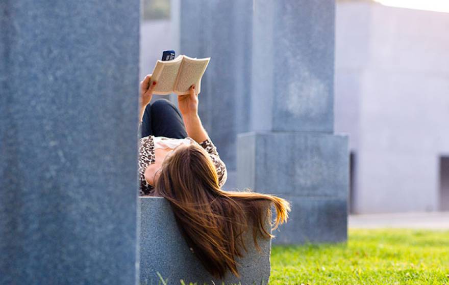 young woman reading book