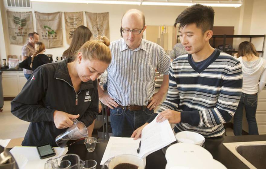 Associate professor William Ristenpart talks with Sabrina Perell, community regional development major, and Kyle Phan, an undeclared major, about the taste of their brew during a UC Davis “Design of Coffee” class in 2015. UC Davis is now establishing a Co