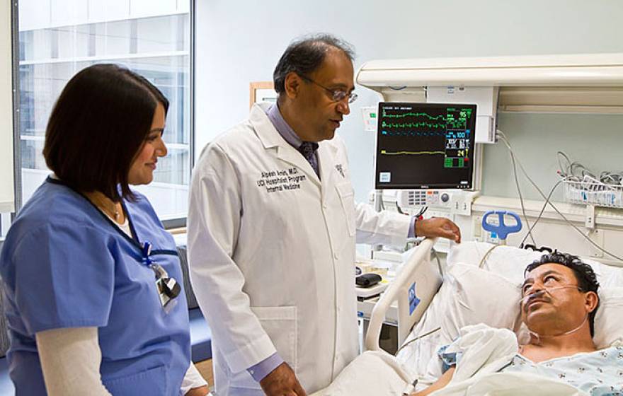 Dr. Alpesh Amin (center) with medical staffer and patient
