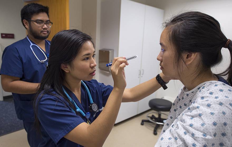 Bernadette Abadilla checks out fellow UCI nursing student Samantha Lee as Jon Frigillana, also a nursing student, watches. The top-ranked program has been elevated to a full-fledged nursing school by the UC regents.