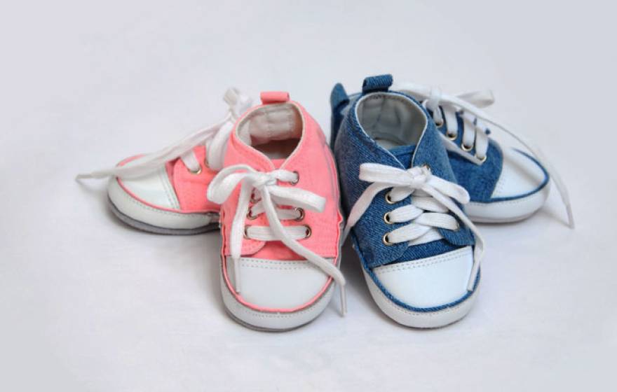 Baby girl and baby boy shoes next to each other