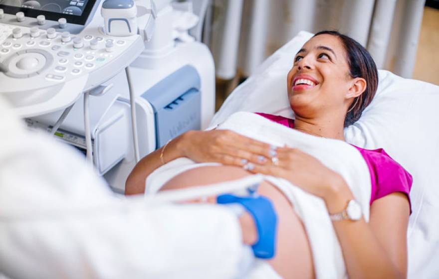 Happy pregnant woman at UCLA Health being screened