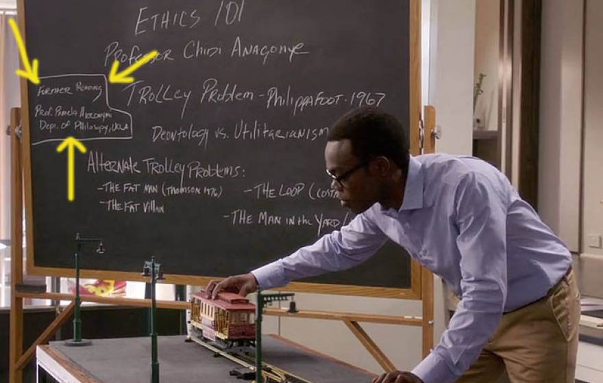 A character plays with a toy trolley in The Good Place