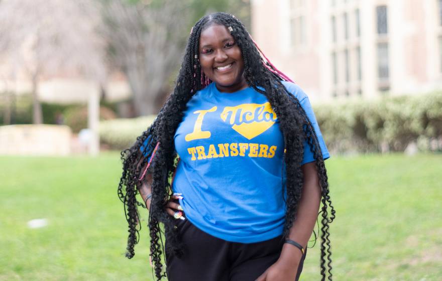 Black woman smiling with a T-shirt that says I UCLA-heart Transfers