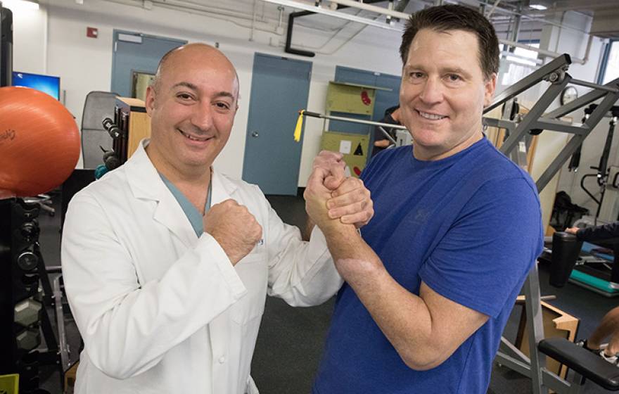 Dr. Kodi Azari, director of the UCLA Hand Transplant program, gets a good grip on Jonathan Koch's transplanted hand. Azari led the surgical teams that amputated Koch's hand and later transplanted a donor hand.