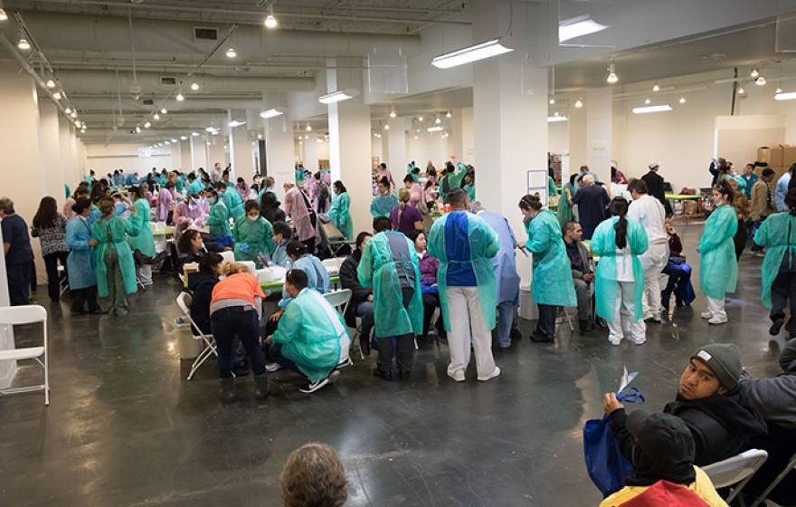 Volunteer dentists treat some of the 1,200 patients who received cleanings, fillings, extractions, partial dentures, root canals and oral cancer screenings at the 2017 Care Harbor Clinic.