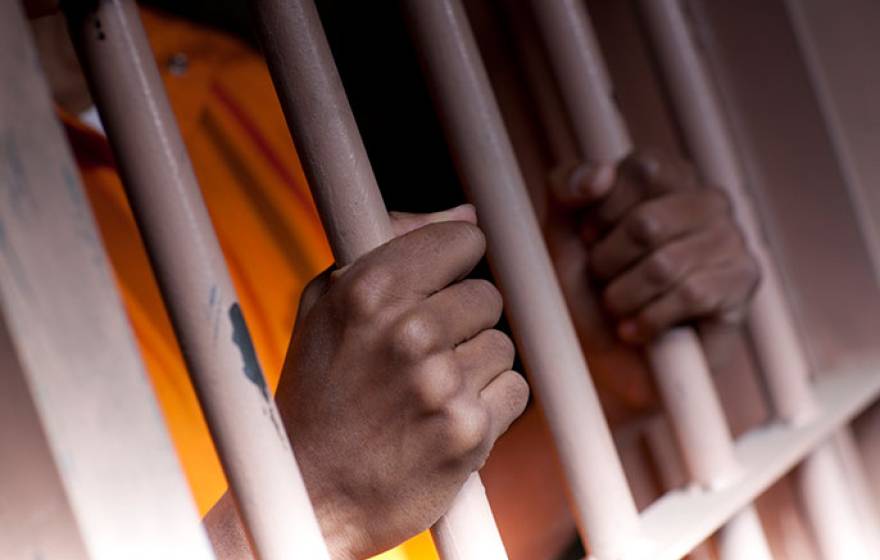 hands on prison bars