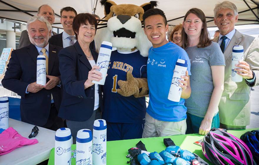 UC Global Food Initiative fellow Hoaithi Dang (right of mascot) is doing his part to make UC Merced a green campus.