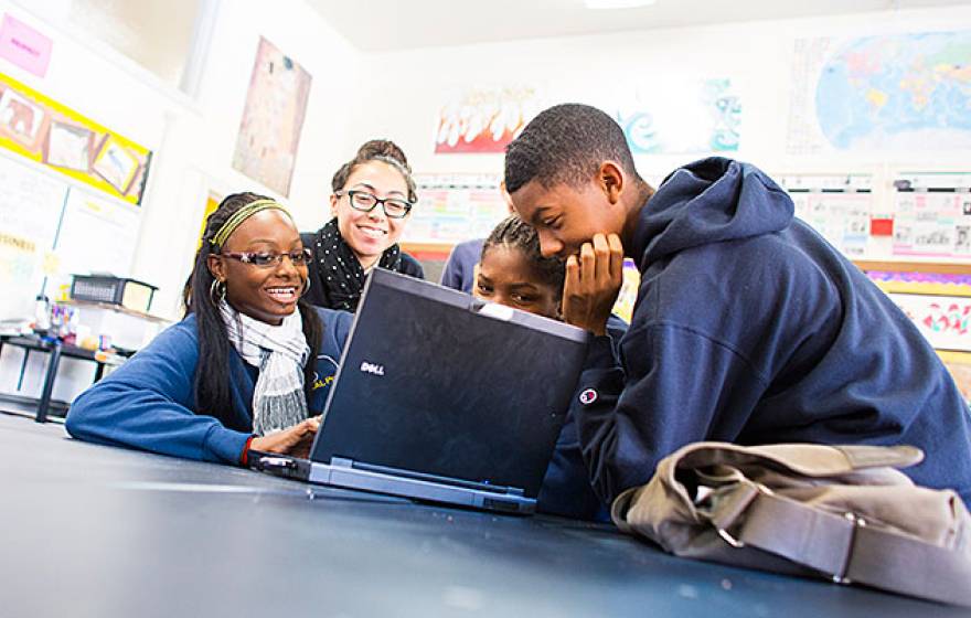 students around laptop