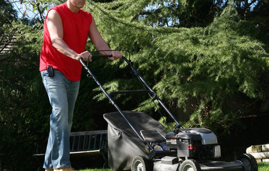 man using lawnmower