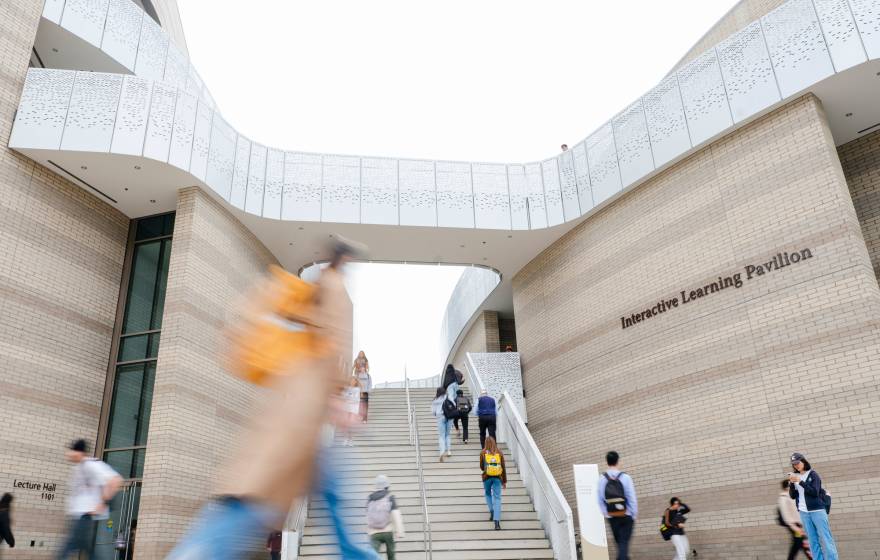 Students walk on the UC Santa Barbara campus in front of the Interactive Learning Pavilion