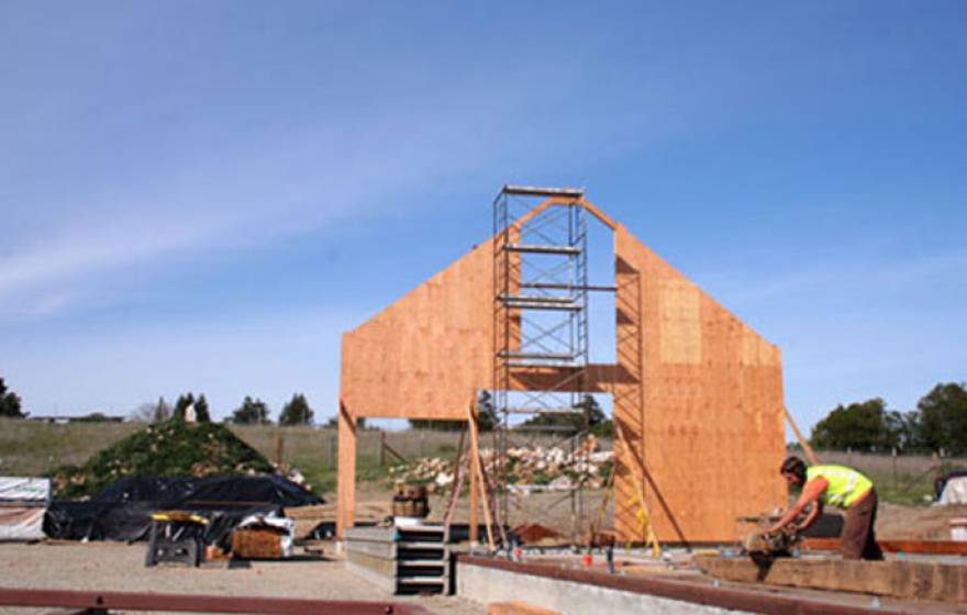 A craftsman from Santa Cruz Timberframes works on an original timber slated to become part of the re-creation of the Cowell Ranch Hay Barn.