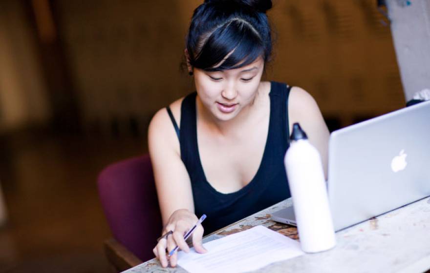 Young woman studies at computer