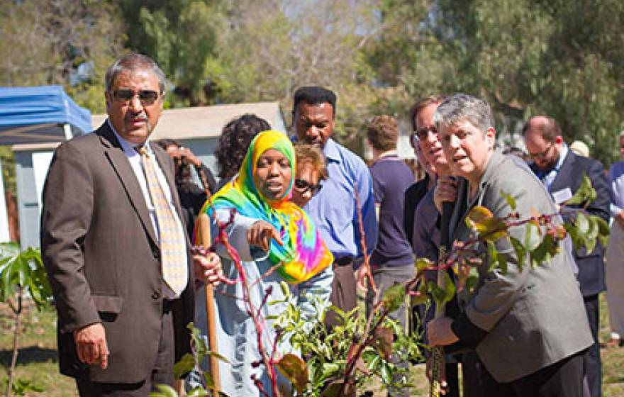 University of California President Janet Napolitano and UC San Diego Chancellor Pradeep K. Khosla listen as volunteer Karemah Alhark talks about the Ocean View Growing Grounds.