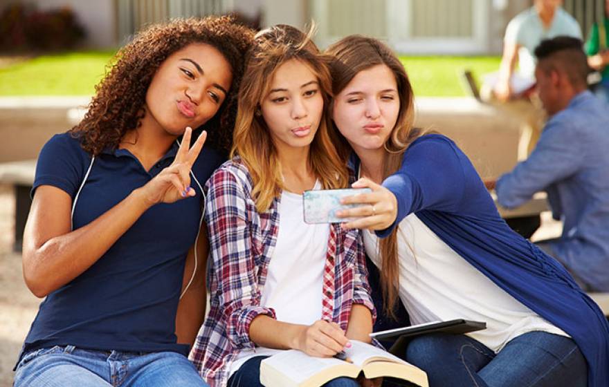 teen girls taking selfie