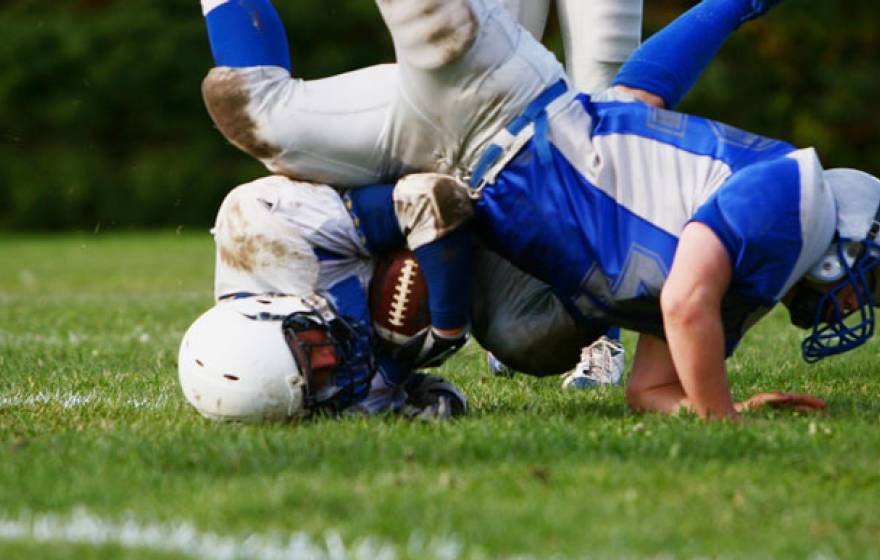 Two boys playing football