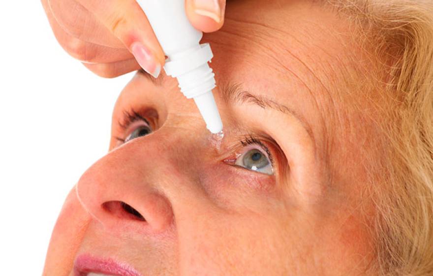 woman administering eye drops