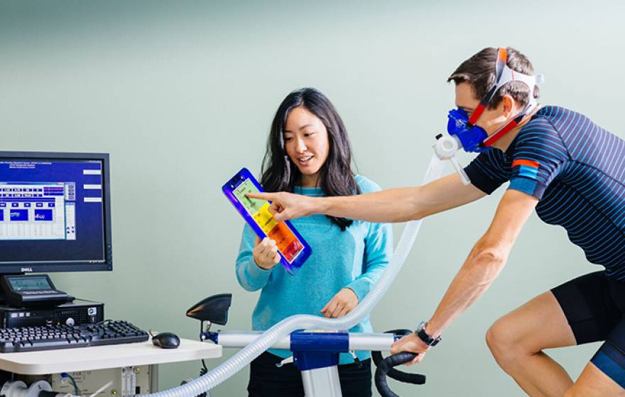 UC San Francisco research fellow Cheri Mah, shown here with cyclist Kurt Wolfgang, studies sleep and performance in elite athletes, and consults with professional sports teams to improve their athletes’ sleep habits.