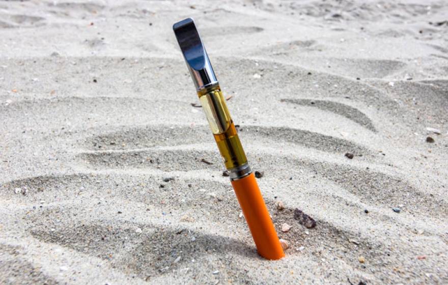 Vape pen stuck in sand