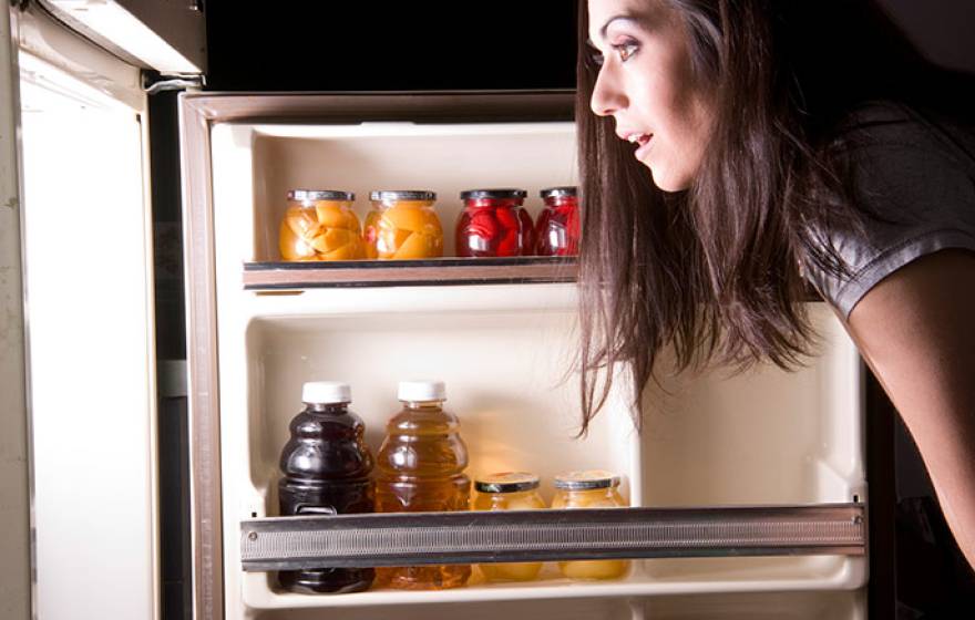 woman looking into refrigerator