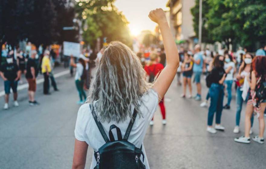 Women marching down the street protesting