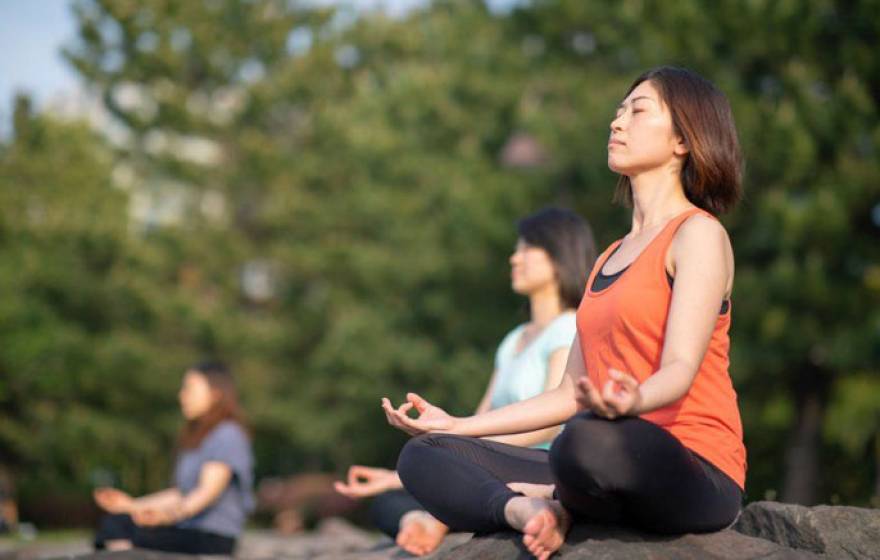 Women meditating outdoors