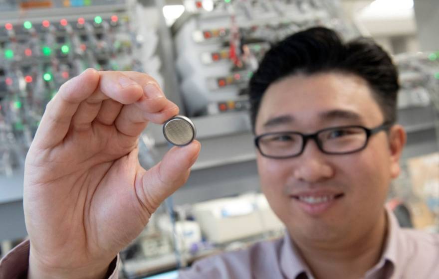 Huolin Xin, UC Irvine professor of physics & astronomy, holds up a small battery