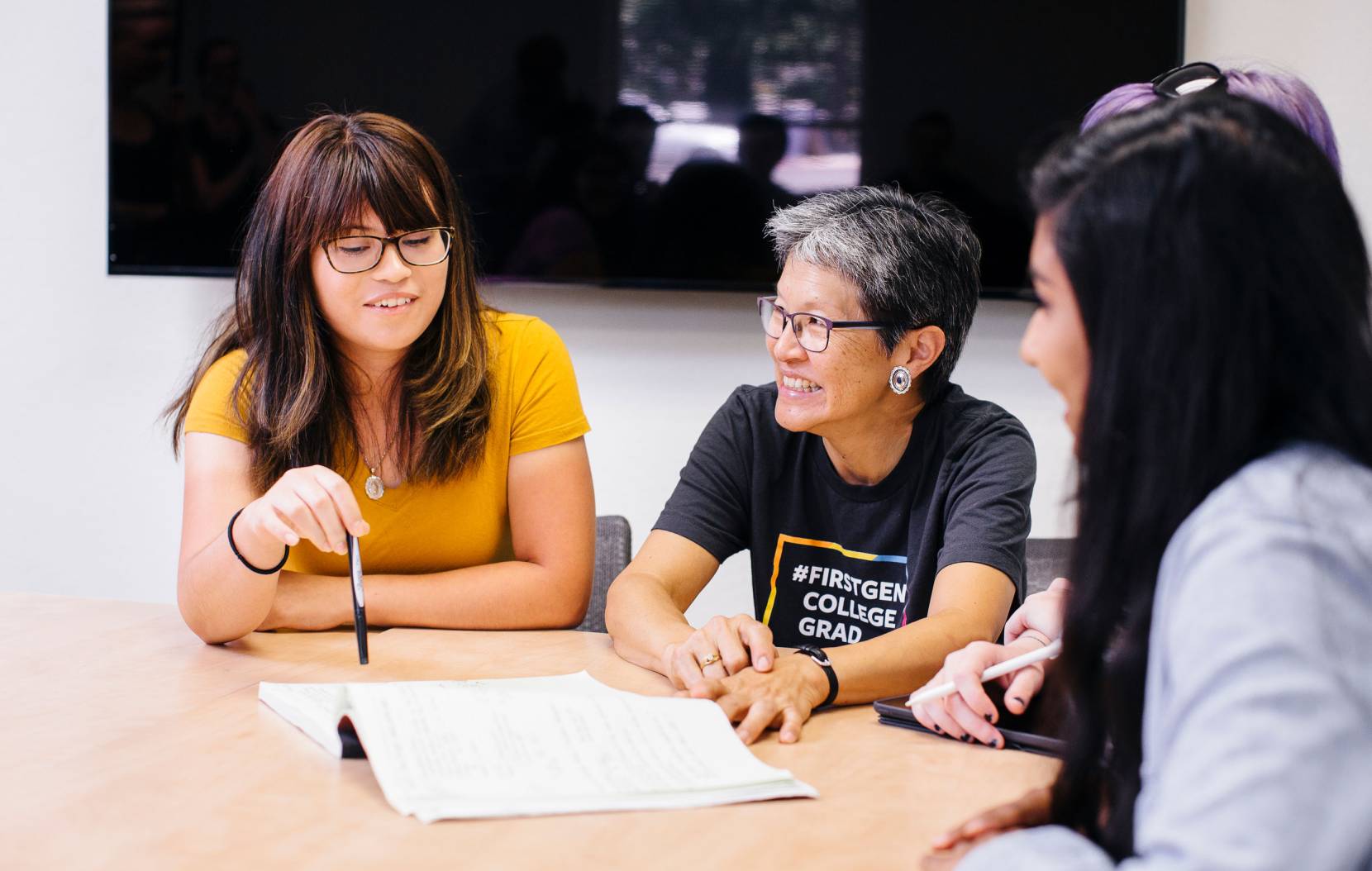 Students sitting and talking with faculty member