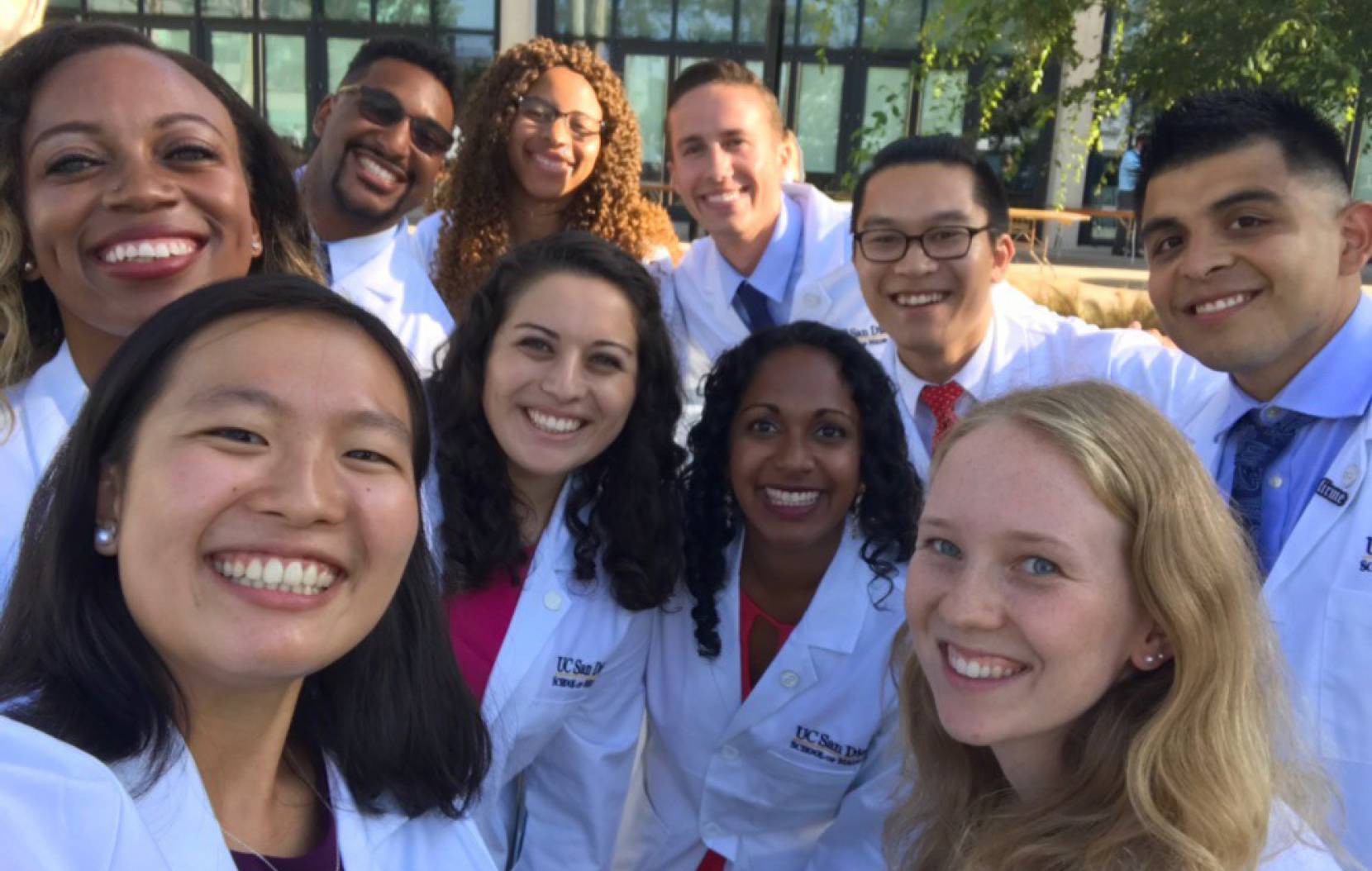 UCSD medical students doing a group selfie in white coats