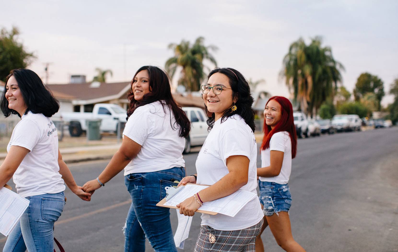 Group of students in white t-shirts, walking in the street