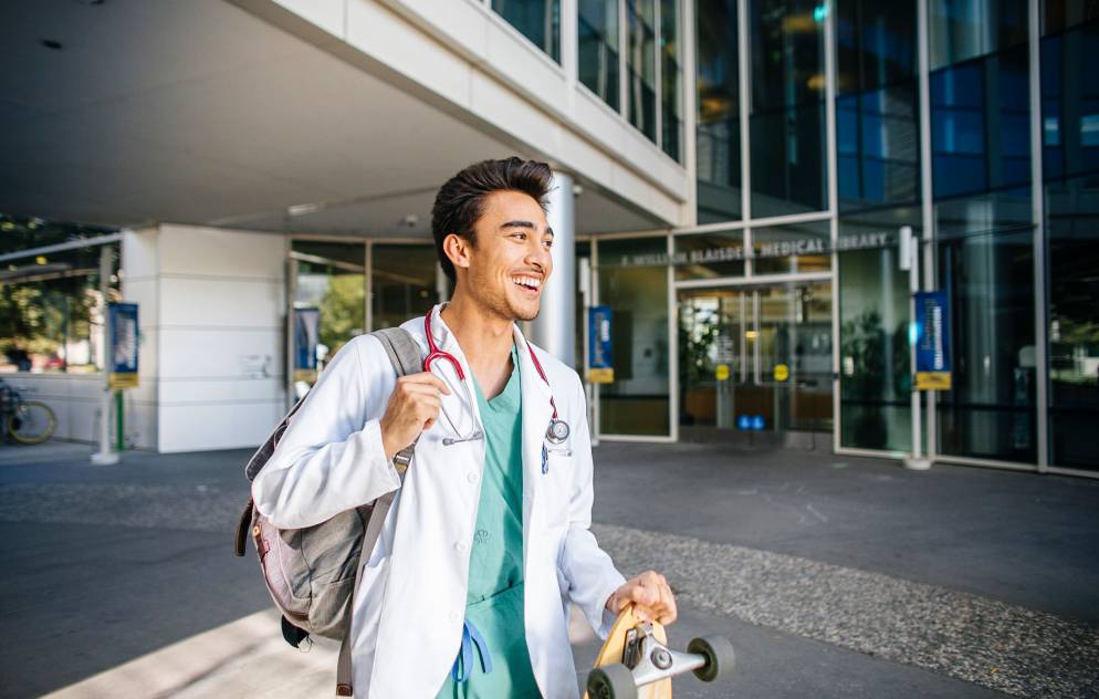 Medical student with backpack and stethoscope.