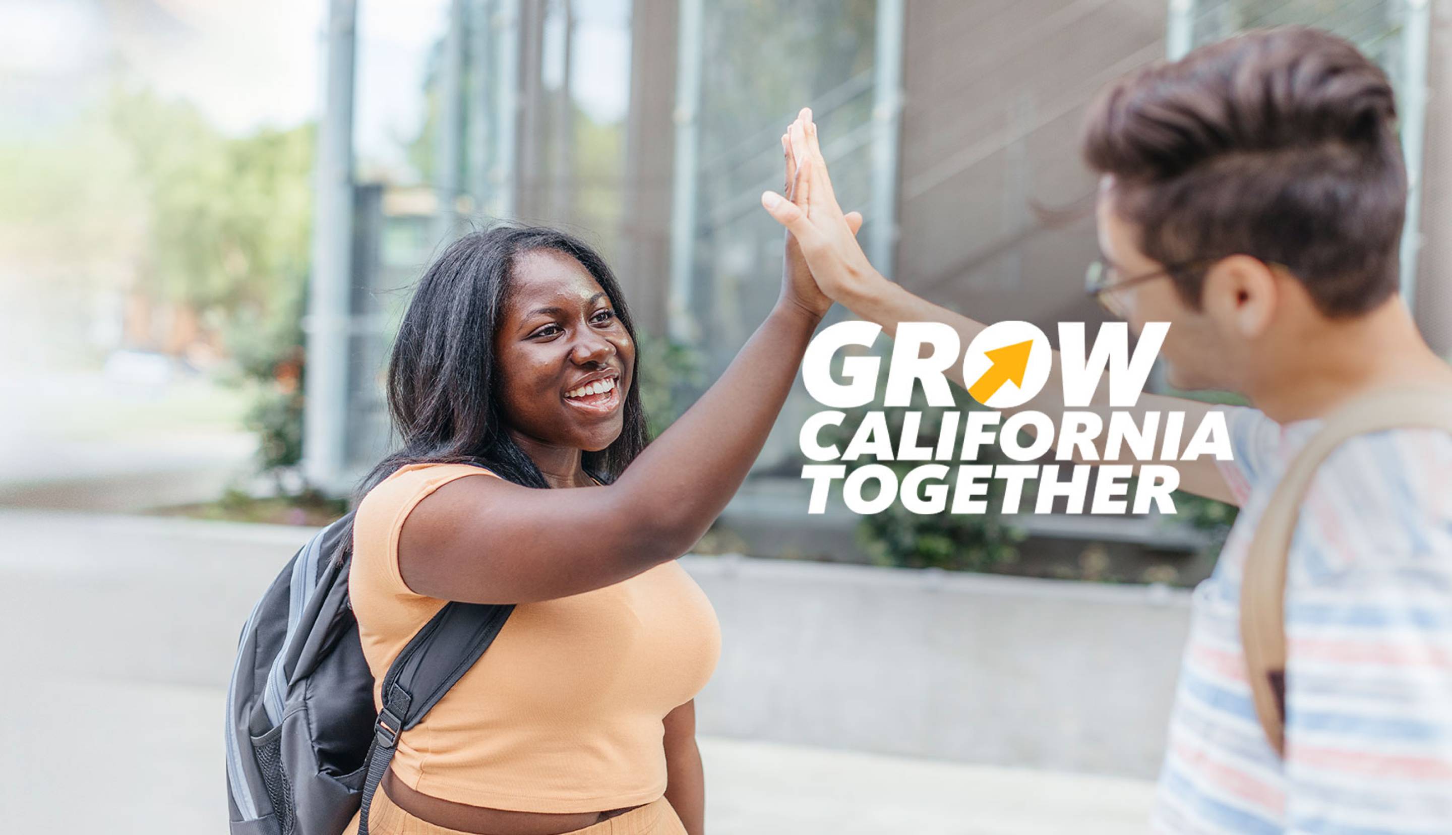 Students giving each other a high five on campus